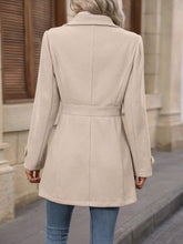 Elegant CheapSeasons signature coat in classic design, shown hanging on a wooden hanger with a neutral background.