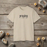 Black "Praying" statement T-shirt by CheapSeasons featuring bold text and casual fit for free spirits.