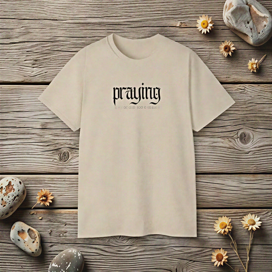 Black "Praying" statement T-shirt by CheapSeasons featuring bold text and casual fit for free spirits.