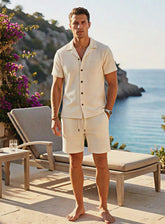 Light-colored Riviera linen resort set by CheapSeasons displayed on a model in a tropical setting.